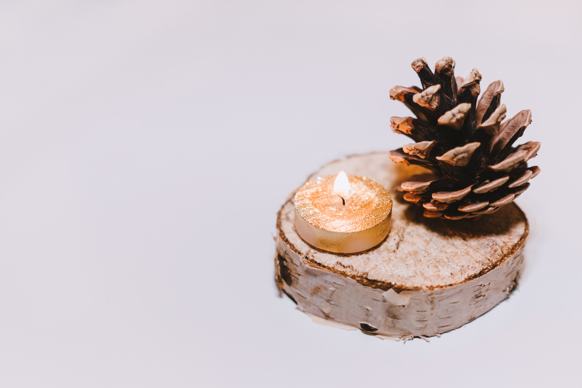 Brown Pine Cone Nut Beside Tealight Candle