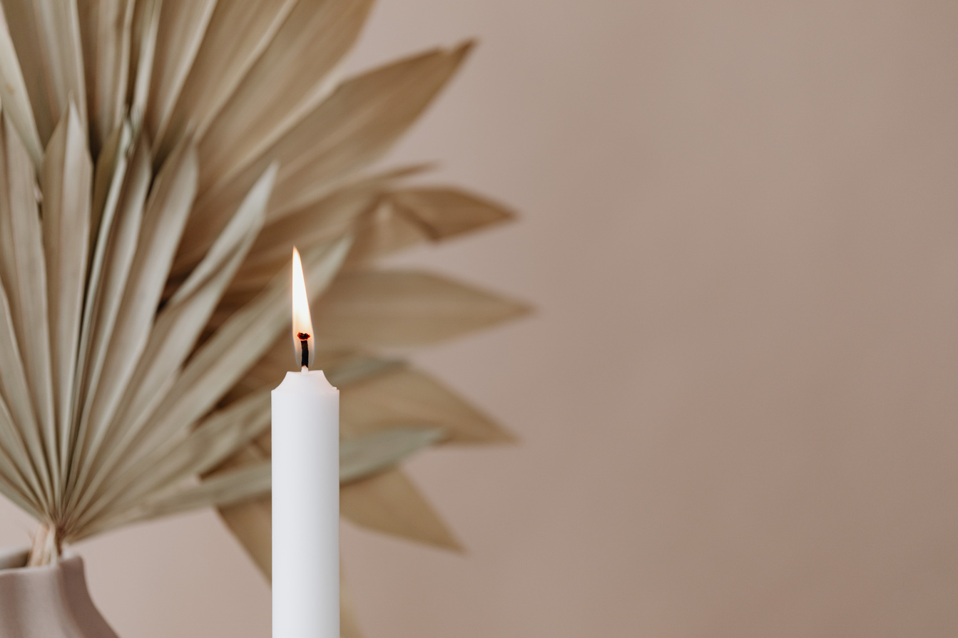 Candle Burning on Minimalist Nude Background